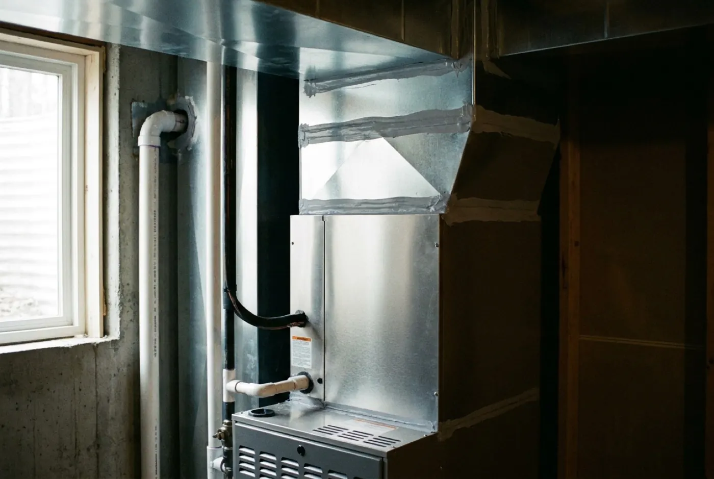 A newly installed high-efficiency furnace with neat sheet metal work